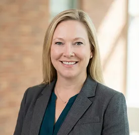 Dr. Jen Johannes, professional healthcare provider in Montrose, Colorado, wearing a grey blazer and teal blouse.